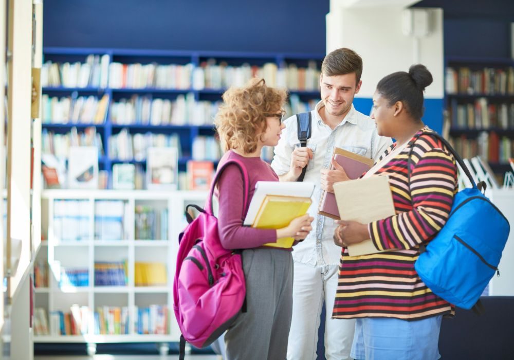 Three students engaged in conversation.